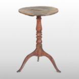 An early 19th century burr elm occasional table, on a baluster turned column and tripod base,