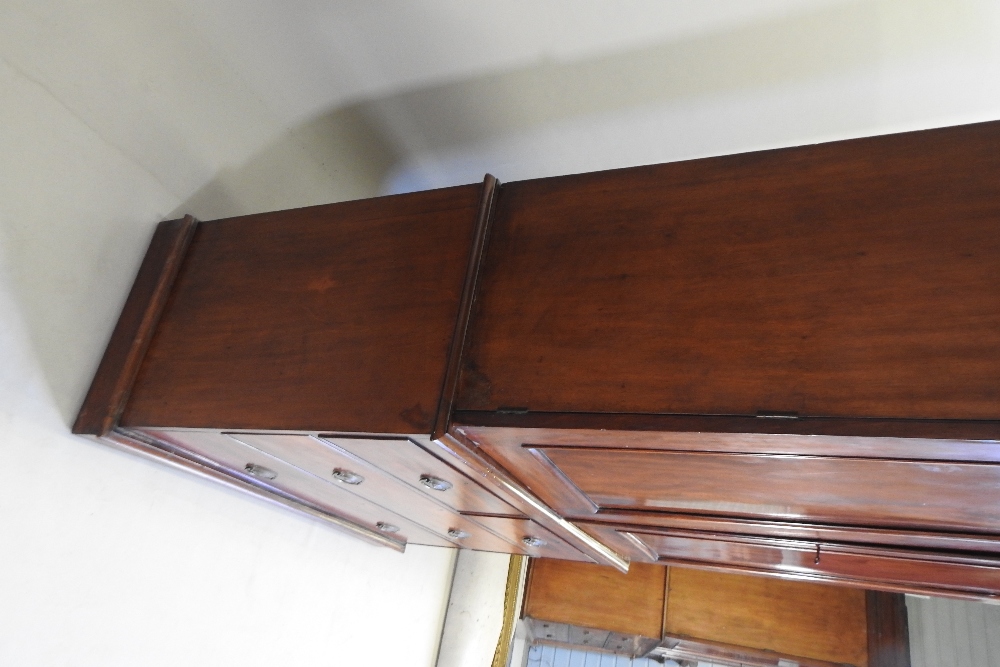 A 19th century mahogany linen press, fitted with slides, standing on a plinth base, - Image 11 of 12