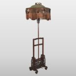 An early 20th century Chinese rosewood standard lamp, with original silk shade,