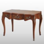 A French walnut and gilt metal mounted side table, of serpentine shape, on cabriole legs,