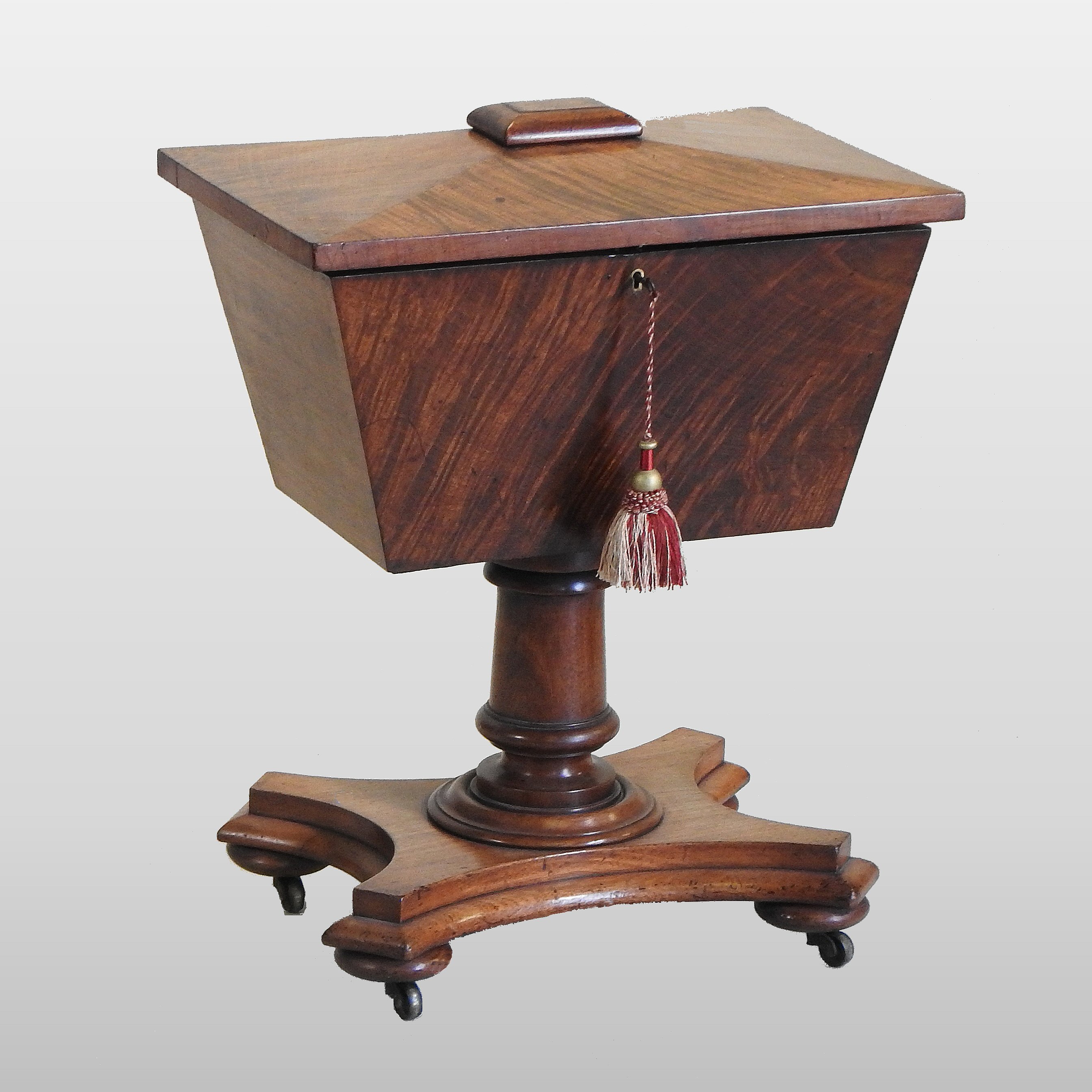 A Regency mahogany teapoy, on a turned column and platform base,