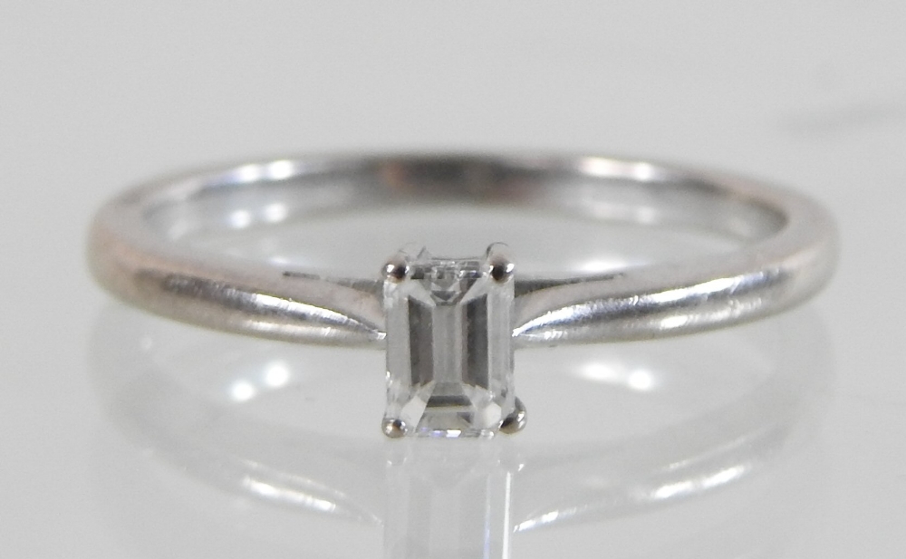 An 18 carat gold solitaire diamond ring, set with a single baguette cut stone, approximately 0. - Image 4 of 4