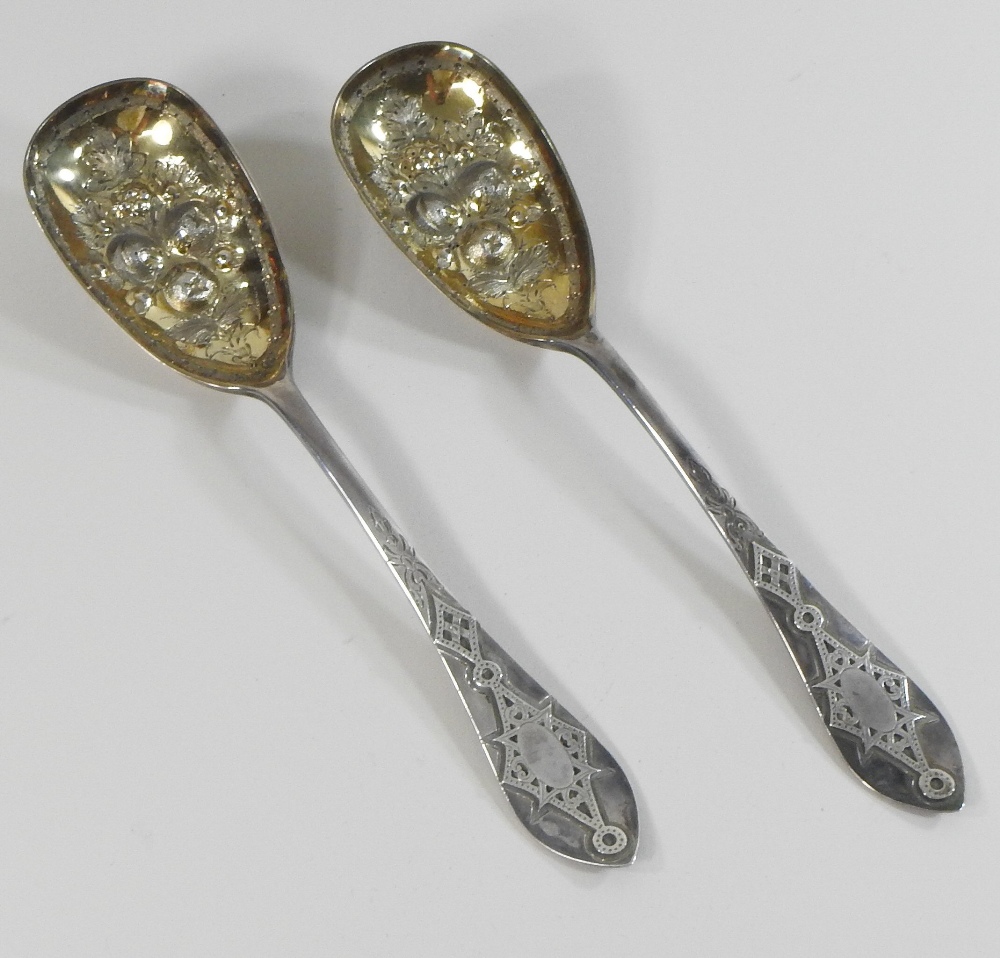 A pair of Victorian silver berry spoons, with engraved decoration and embossed gilt bowls, - Image 4 of 9