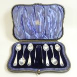 A rare set of six early 20th century silver teaspoons, together with a pair of matching sugar tongs,