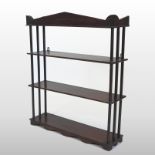 A set of Regency mahogany four tier hanging shelves, with turned supports and wavy shaped apron,