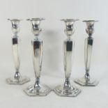 A set of four mid 20th century American silver plated table candlesticks, each of octagonal shape,