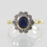 An 18 carat gold sapphire and diamond cluster ring