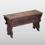 An early 20th century carved oak six plank coffer,