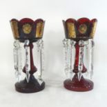 A pair of 19th century Bohemian ruby glass table lustres, with a scalloped rim,