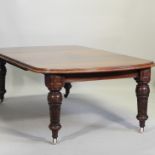 A large Victorian mahogany wind out extending dining table, with three additional leaves,