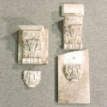A pair of antique carved marble corbels, each with scrolled and reeded decoration,