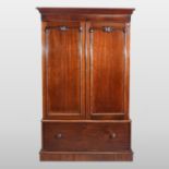 A Victorian mahogany linen press, fitted with slides, enclosed by a pair of panelled doors,