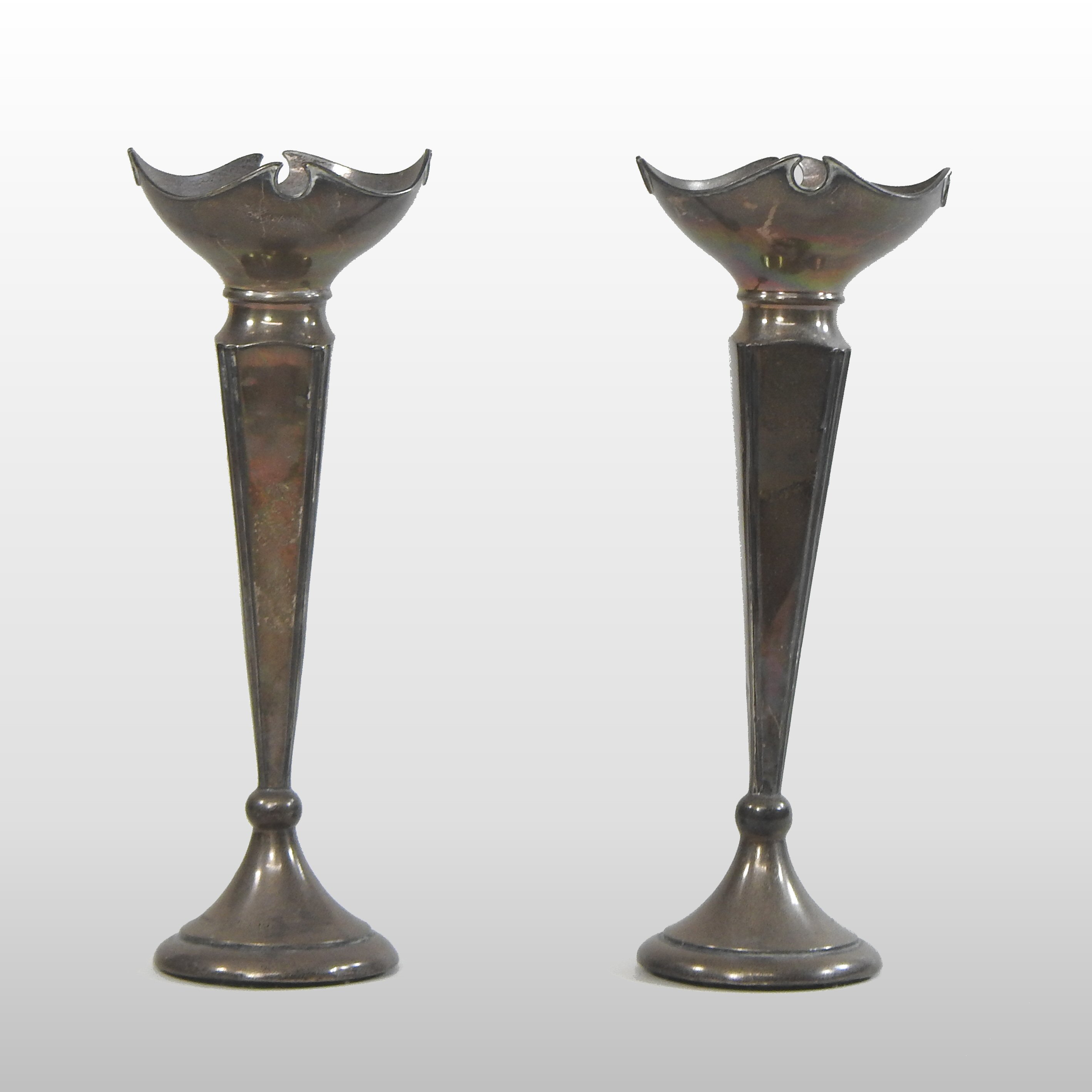 A pair of early 20th century silver spill vases, each of slender shape, with an undulating rim,