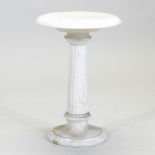 A 20th century white marble jardiniere stand, on a reeded column and circular base,