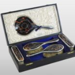 An early 20th century silver and tortoiseshell dressing table set, with pique work decoration,