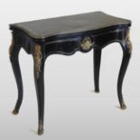 A 19th century French ebonised and cut brass inlaid card table, of serpentine form,