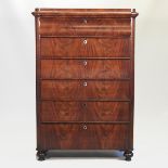A 19th century French mahogany chest, containing six long drawers, standing on turned feet,
