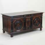 A 17th century oak coffer, with a hinged lid and geometric moulded panels,