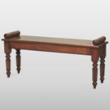 A Regency style mahogany window seat, standing on reeded legs,