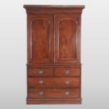 A 19th century mahogany linen press, fitted with slides, standing on a plinth base,