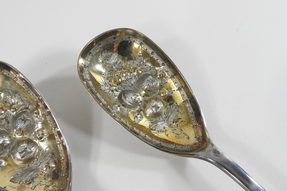 A pair of Victorian silver berry spoons, with engraved decoration and embossed gilt bowls, - Image 7 of 9