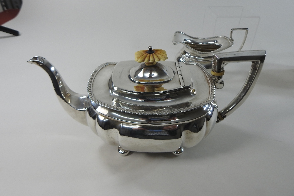 An early 20th century silver three-piece tea service, comprising a teapot, sugar bowl and cream jug, - Image 3 of 12