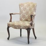 An early 20th century French cream upholstered open armchair, with floral upholstery,