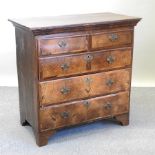 A George II walnut and crossbanded chest of drawers, containing two short above three long drawers,