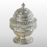A late Victorian silver tea canister, the lid decorated with swags above a half gadrooned body,