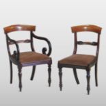 A set of eight William IV carved mahogany dining chairs, each having a bar back and drop in seat,