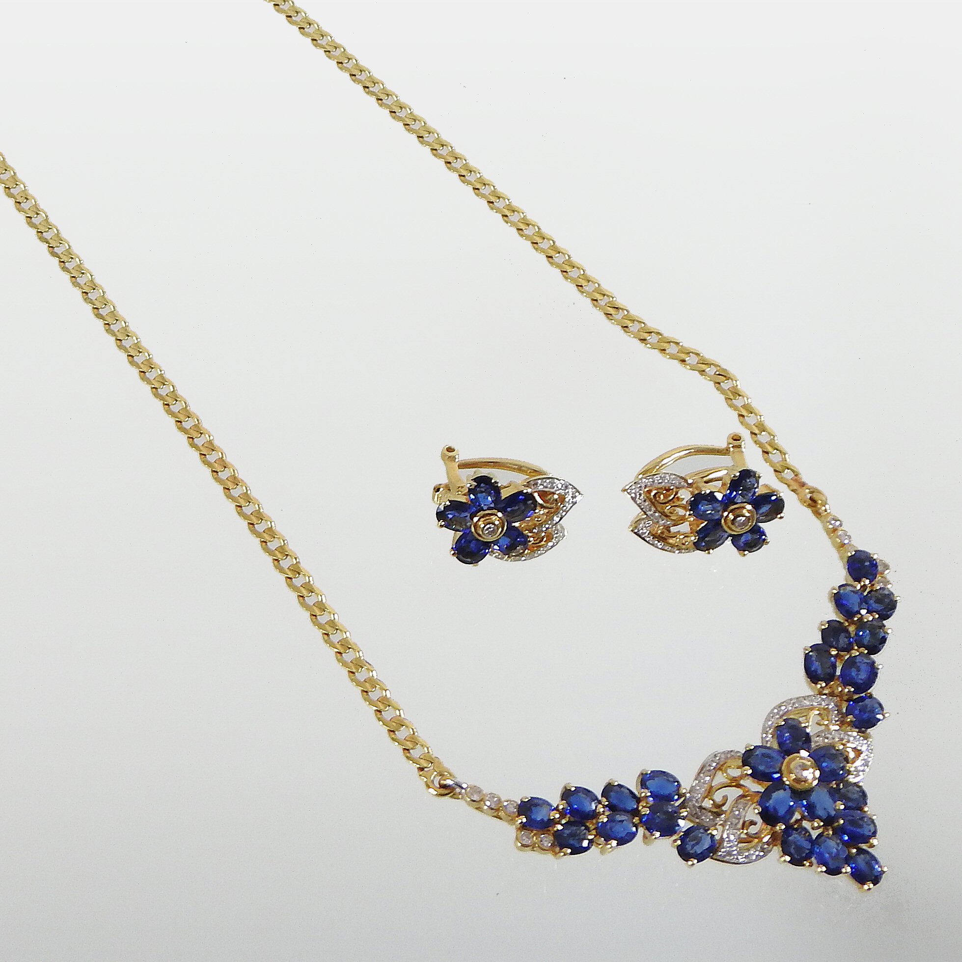 An 18 carat gold sapphire and diamond necklace and earring set,