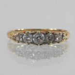 An 18 carat gold five stone diamond ring, set with a single row of graduated stones,