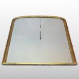 A Victorian gilt framed over mantel mirror, of arched shape, with a moulded surround,
