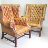 A pair of large George I style wing armchairs, upholstered in brown leather, with button backs,