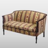 An early 20th century mahogany striped upholstered sofa, on turned legs,