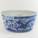 A large Chinese porcelain blue and white jardiniere, decorated with a dragon,