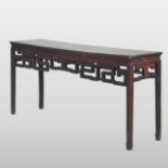 A Chinese hardwood altar table, with a carved frieze, standing on square legs,