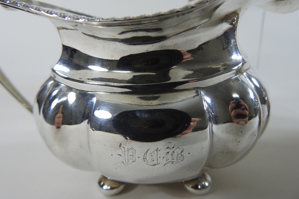 An early 20th century silver three-piece tea service, comprising a teapot, sugar bowl and cream jug, - Image 5 of 12