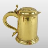An 18th century style gilded brass tankard, of plain shape, with a hinged lid and scrolled handle,