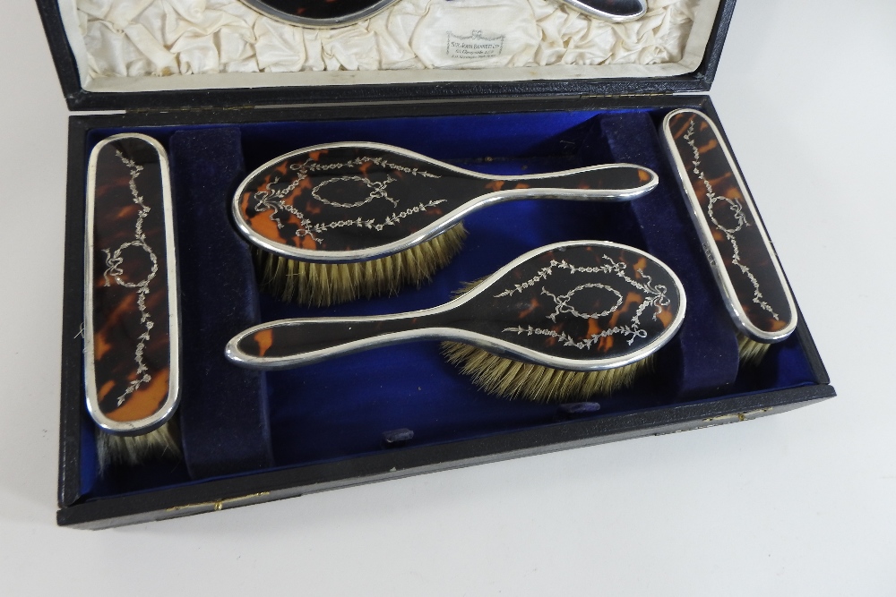 An early 20th century silver and tortoiseshell dressing table set, with pique work decoration, - Image 5 of 5