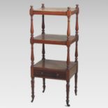A Victorian mahogany three tier whatnot, united by turned supports, with a drawer below,