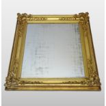 A large 19th century carved wood and gilt gesso framed wall mirror,