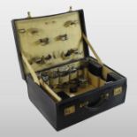 An early 20th century travelling vanity case, inscribed in gold with the initials DHS to the lid,