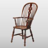 A 19th century elm seated Windsor style armchair,