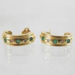 A pair of 18 carat gold emerald and diamond set earrings