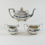 An early 20th century silver three-piece tea service, comprising a teapot, sugar bowl and cream jug,