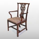A George III mahogany elbow chair, in the manner of Thomas Chippendale, with ribbon carved splat,