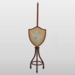 A 19th century Sheraton style satinwood pole screen,