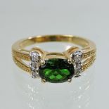 An 18 carat gold diopside and diamond ring, with diamond shoulders,