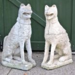 A pair of reconstituted stone models of seated dogs,